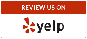 A rectangular button inviting users to review Emergency Restoration on Yelp, featuring the Yelp logo on a white and red background.